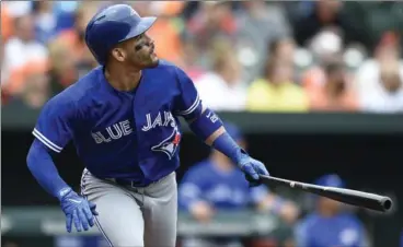  ?? GAIL BURTON, THE ASSOCIATED PRESS ?? Toronto Blue Jays’ Devon Travis watches his three-run home run sail out of the ballpark against the Baltimore Orioles in the first inning of Sunday’s game.