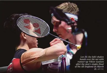  ?? AFP PIC ?? Lee Zii Jia (left) shakes hands over the net with runner-up Viktor Axelsen after the men’s singles final of the All England on March 21.