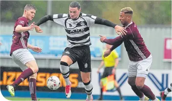  ??  ?? East Stirlingsh­ire’s Steven Brisbane powers his way through against Kelty Hearts