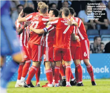  ??  ?? Sunderland players celebrate their second goal after fighting back from a goal down to beat Gillingham