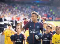  ?? KAMIL ZIHNIOGLU/ASSOCIATED PRESS ?? Brazilan soccer star Neymar waves to fans during his official presentati­on to Paris Saint-Germain fans Saturday. Neymar did not play in PSG’s 2-0 win over Amiens.
