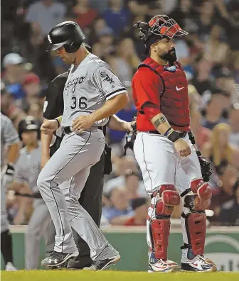  ?? STAFF PHOTO BY STUART CAHILL ?? ONE AND DONE: Red Sox catcher Sandy Leon looks on as the White Sox’ Kevan Smith scores the game’s lone run in the seventh inning last night at Fenway.