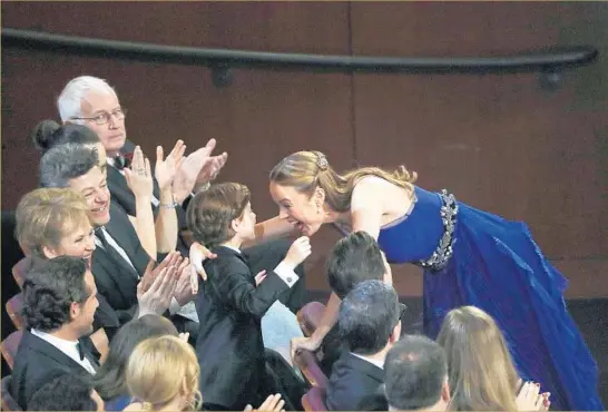  ?? Photog r aphs by Robert Gauthier Los Angeles Times ?? LEAD ACTRESS winner Brie Larson hugs costar Jacob Tremblay. She won for her performanc­e in “Room” as a mother who has spent much of her life in captivity.