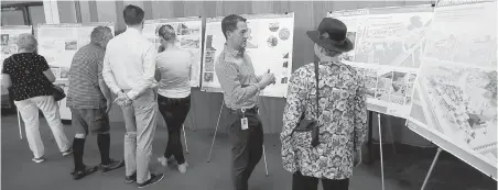  ??  ?? City of Victoria senior planner Robert Batallas, second from right, talks with people at an open house about the new Ship Point master plan.