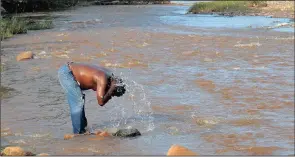  ??  ?? James Mofolo a ZCC member says the water in the Olifants is holy. He drinks it and believes he is closer to God when he makes contact with the river.