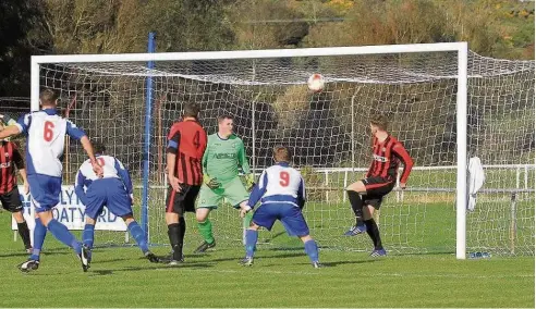  ??  ?? ● Porthmadog were lucky not to concede from this effort by Holyhead’s Mel McGinness (No9 - blue and white). Picture: ANTHONY WARD