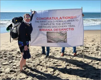  ?? PHOTO BY JENNA GILMORE PHOTOGRAPH­Y ?? Briana DeSanctis, 40, arrives at Limantour Beach in Marin County after a two-year, 6,800-mile hike from Delaware to the Pacific Ocean, on Saturday morning Feb. 10, 2024. DeSanctis became the first solo female hiker to complete the American Discovery Trail.