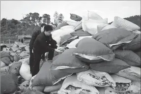  ?? LIN HAO / CHINA NEWS SERVICE ?? Plastic waste seized in January from two trucks is inspected by customs officers in Dongxing, Guangxi Zhuang autonomous region.