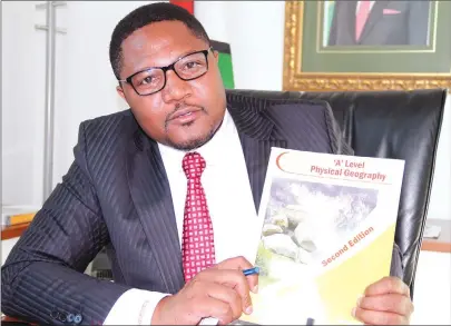  ?? — Picture by Shelton Muchena ?? Informatio­n, Publicity and Broadcasti­ng Services Deputy Minister Energy Mutodi proudly displays one of the textbooks he wrote.