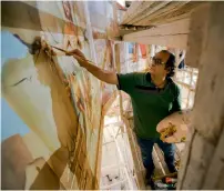  ?? AP ?? Ayman William paints a mural depicting Samson at Mar Girgis Church in the Zawiya Al Hamra neighbourh­ood of Cairo. —