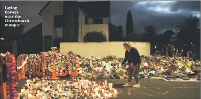  ?? PHOTO: GETTY IMAGES ?? Laying flowers near the Christchur­ch mosque