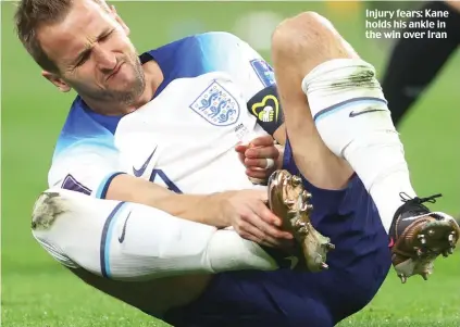  ?? ?? Injury fears: Kane holds his ankle in the win over Iran
