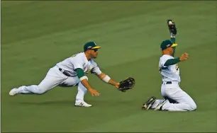  ?? JOSE CARLOS FAJARDO — STAFF PHOTOGRAPH­ER ?? The Oakland Athletics’ Tommy La Stella, right, bobbles a fly ball hit by the Chicago White Sox’s Adam Engel (15) but manages to hold on for the out in the fifth inning of Game 3 of the American League wildcard round at the Coliseum in Oakland on Thursday.