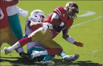  ?? JED JACOBSOHN — THE ASSOCIATED PRESS ?? Dolphins defensive end Zach Sieler, left, sacks 49ers quarterbac­k Jimmy Garoppolo during the first half on Sunday in Santa Clara.