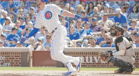  ??  ?? Third baseman Kris Bryant blasted a two- run homer off the left- field video board at Wrigley Field in the first inning. Bryant has hit the board four times. | KAMIL KRZACZYNSK­I/ AP