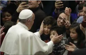  ?? ALESSANDRA TARANTINO — ASSOCIATED PRESS ?? In this Thursday, Dec. 15, 2016file photo, Pope Francis greets children from the Vatican’s Bambino Gesu Pediatric Hospital. During the audience in the Vatican’s Paul VI hall, Francis exhorted hospital caregivers not to fall prey to corruption, which he...