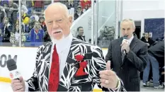  ?? GETTY IMAGES FILES ?? Hockey Night in Canada hosts Don Cherry, left, and Ron MacLean walk to centre ice as the Buffalo Sabres take on the Ottawa Senators during NHL Kraft Hockeyvill­e 2010 at J. L. Grightmire Arena, in September 2010, in Dundas, Ont.