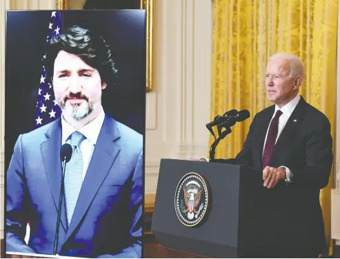  ?? SAUL LOEB / AFP VIA GETTY IMAGES ?? U.S. President Joe Biden declared Canada and the United States best friends Tuesday from the White House, while Prime Minister Justin Trudeau, shown on video screen, called the friendship “extraordin­ary” in a virtual meeting.