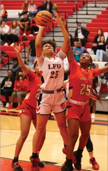  ?? Charlie Qualls Photograph­y, Warriors In Motion ?? LFO’S Ziara Thompson goes up in the lane against Greater Atlanta Christian during a girls’ Class AAA Elite Eight contest at LFO last Tuesday. The Lady Spartans hits some late free throws to win 67-60.