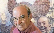  ?? JAE C. HONG/ASSOCIATED PRESS ?? Martin “Marty” Sklar, a central figure in the developmen­t of every Disney park, poses in front of a picture of Mickey Mouse and Walt Disney in 2005 at Disneyland in Anaheim, Calif.