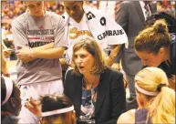  ?? Tim Clayton / Corbis via Getty Images ?? Anne Donovan, center, then head coach of the Connecticu­t Sun, talks to her players during a timeout during a game with the Liberty in 2014.