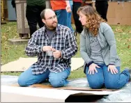  ?? Janelle Jessen/Herald-Leader ?? James and Keri Harris worked on building a shelter out of cardboard, tarps and duct tape for One Night Without a Home.