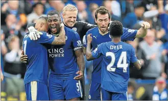  ?? Picture: GETTY IMAGES ?? TEAMWORK: Leicester captain Wes Morgan, second left, celebrates his goal against Southampto­n earlier this month with teammates Danny Simpson, Kasper Schmeichel, Christian Fuchs and Nathan Dyer.