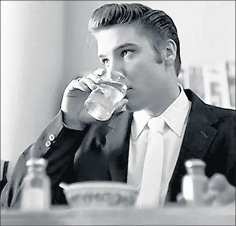  ?? ALFRED WERTHEIMER PHOTO ?? Elvis Presley, then 21, enjoys a bowl of chili on June 30, 1956, at the lunch counter of the Jefferson Hotel in Richmond, Va.