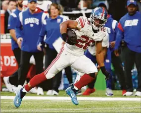  ?? Steve Luciano / Associated Press ?? New York Giants running back Saquon Barkley runs the ball up the field against the Green Bay Packers at Tottenham Hotspur Stadium on Sunday in London.