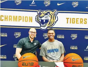  ?? Rice) ?? Champion Christian College head men’s basketball coach Mo Capaci sits with Cutter Morning Star senior signee Ahmad Davis in Eagle Arena on signing day, Thursday. (The Sentinel-Record/Bryan