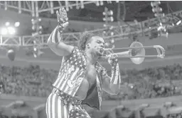  ??  ?? Xavier Woods plays a trombone as part of his ring entrance with WWE’s New Day tag team. New Day released its “Book of Booty” on Tuesday. COURTESY OF WWE