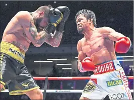  ?? MOHD RASFANMOHD RASFAN — GETTY IMAGES ?? Manny Pacquiao, right, knocked out Argentina’s Lucas Matthysse in the seventh round Saturday night to win the WBA welterweig­ht title — his first stoppage win in nine years.