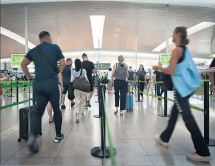  ?? / JUAN BARBOSA ?? Varios pasajeros, el domingo en un control de seguridad del aeropuerto de Barcelona.