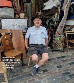  ??  ?? Ron Scott of Scott’s Furniture Mart sits outside his bulging warehouse