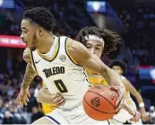  ?? RON SCHWANE / AP ?? Toledo guard Ra’Heim Moss drives against Kent State in the championsh­ip game of the Mid-American Conference tournament last month. The Springfiel­d High School graduate intends to transfer and reportedly has narrowed his choices to four, including Ohio State.