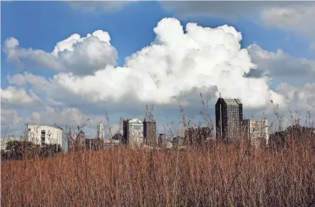  ?? FRED SQUILLANTE/COLUMBUS DISPATCH ?? Clouds and Scioto Audubon Metro Park frame the Downtown skyline on Tuesday. It hasn’t been feeling like fall, and temperatur­es will remain well above normal into next week. But watch out for rain today and Friday.