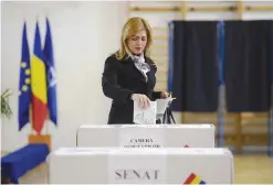  ?? — AFP ?? BUCHAREST: A Romanian woman casts her ballot at a polling station in Bucharest during parliament­ary elections.