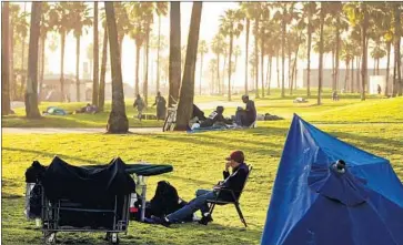  ?? Al Seib Los Angeles Times ?? HOMELESS people gather in Venice in 2014. Two groups from the community, concerned about proposed projects to help the homeless there, are suing the city, saying it failed to fully consider environmen­tal effects.