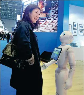  ?? FENG YONGBIN / CHINA DAILY ?? A visitor communicat­es