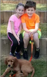  ??  ?? Maisy and Sam Kehoe with their dog Stitch.