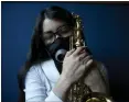  ?? GINNETTE RIQUELME — THE ASSOCIATED PRESS ?? Maria Elena R'os holds her saxophone at the end of a rehearsal at the National Autonomous University of Mexico music department in Mexico City on Tuesday.