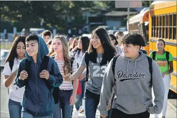  ?? Irfan Khan Los Angeles Times ?? STUDENTS arrive at Dodson Middle School in Rancho Palos Verdes to start the school year in August. On Thursday, the head of the teachers union called for L.A. Unified to shut campuses as a coronaviru­s precaution.