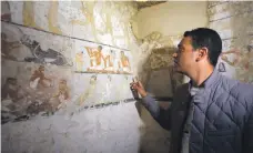  ?? EPA; AFP ?? Far left, wall paintings in Hetpet’s tomb show her watching hunting and fishing scenes; above, detailed scenes depict ancient life; middle, many of the images are well preserved; workers outside the tomb of the Old Kingdom priestess, below