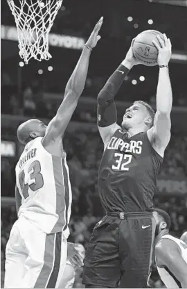  ?? Mark J. Terrill Associated Press ?? PISTONS FORWARD Anthony Tolliver, left, defends the Clippers’ Blake Griffin during the first half of Detroit’s 95-87 victory at Staples Center.