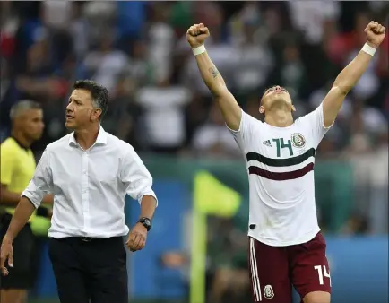  ?? Martin Meissner ?? The Associated Press Mexico’s Javier Hernandez celebrates beside coach Juan Carlos Osorio after the team defeated South Korea 2-1 in a World Cup match Saturday in Rostov-on-don, Russia. Mexico’s odds to win the World Cup have been adjusted down to 20-1.