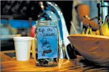  ?? JOSE M. OSORIO/CHICAGO TRIBUNE ?? An old-fashioned tip jar sits on the counter at Dollop Coffee Co. in Chicago’s Gold Coast neighborho­od.