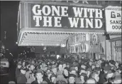  ?? THE ASSOCIATED PRESS ?? A Croud gAthers outside the Astor TheAter in Neu York for the premiere of “Gone uith the Wind” on DeC. 19, 1939.