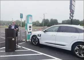  ?? Abigail Brone / Hearst Connecticu­t Media ?? The state’s first universal electric-car-charging stations are installed at the southbound Interstate 95 service plaza in Madison. DOT Commission­er Joe Giulietti speaks about the station’s benefits on Friday.