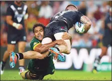  ??  ?? New Zealand’s Simon Mannering (right), is tackled by Australia’s Sam Thaiday during the ANZAC rugby league test match at Suncorp Stadium in Brisbane, on
May 3. (AFP)