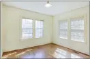  ?? ?? Large windows in one of the home’s additional bedrooms provide a light and airy feel.